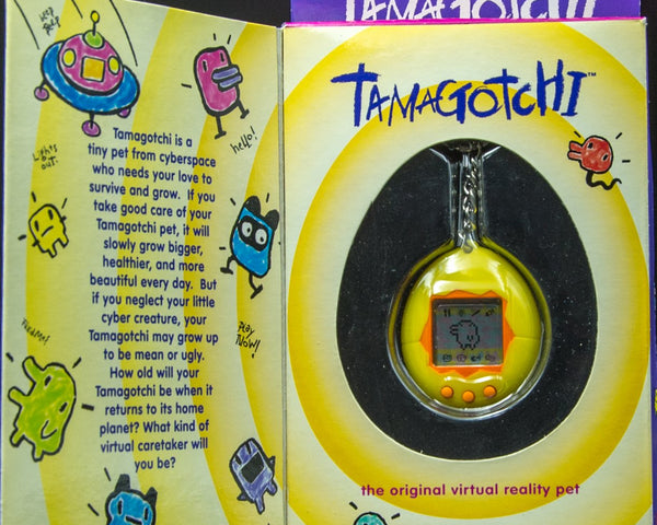 1996 Bandai Virtual Pet Handheld System Tamagotchi Yellow with Orange 